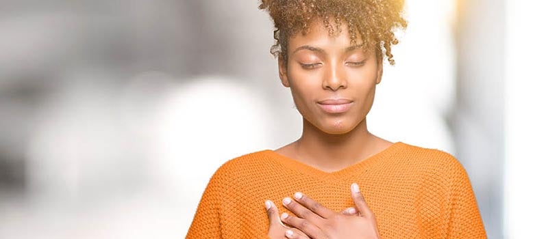 Woman holding chest