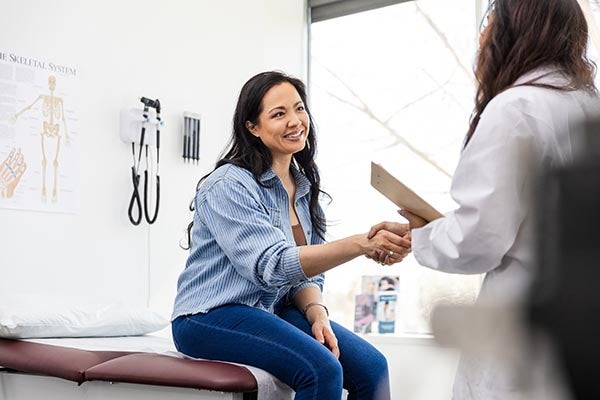 woman shaking doctor's hand