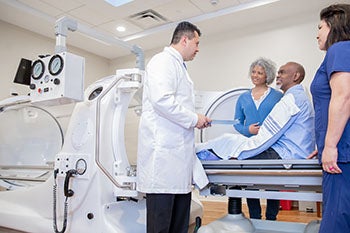 A doctor speaking with a patient before his Hyperbaric Oxygen Therapy