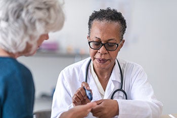 A doctor examining a patient's hand
