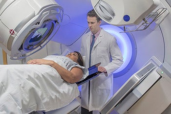 A doctor speaking with a patient before their MRI scan