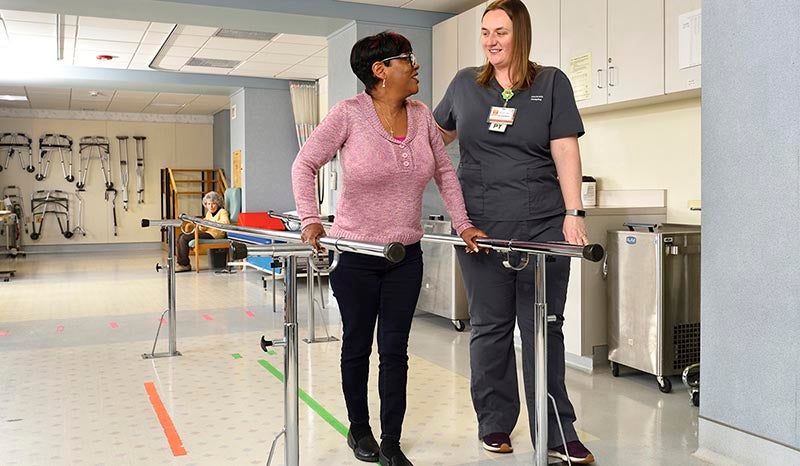 A patient in physical therapy with a nurse